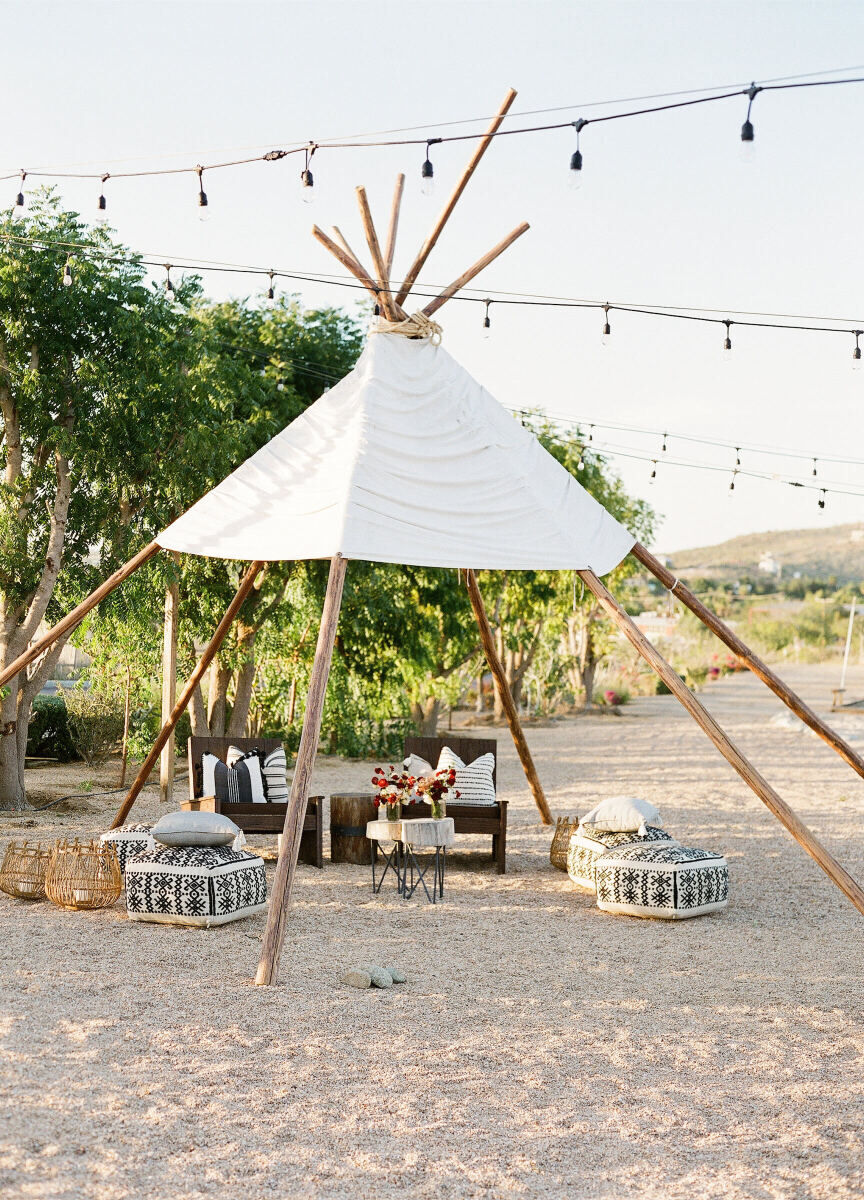 Mexican wedding: desert themed wedding lounge furniture underneath an outdoor, open-air teepee 