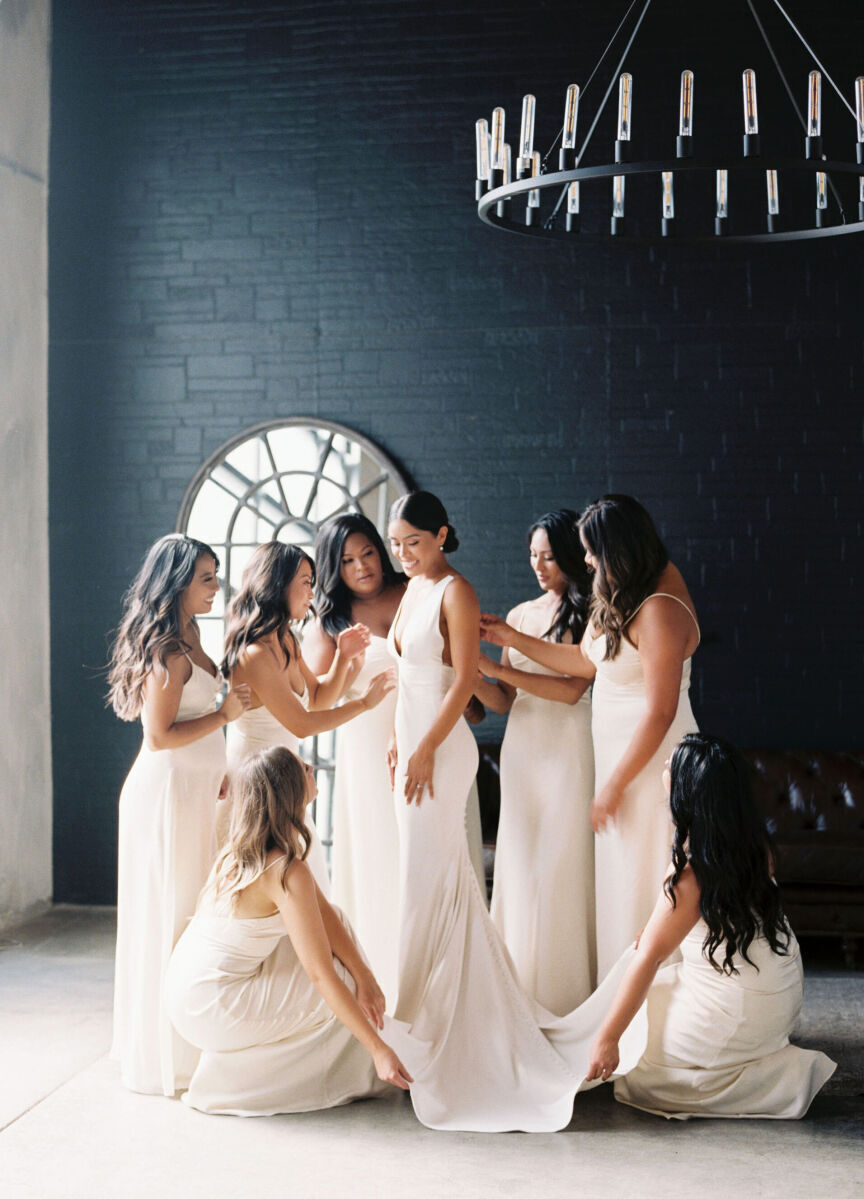 Best Places for a Minimalist Wedding: A bridal party doing the final touches of a bride's gown at Bloc.