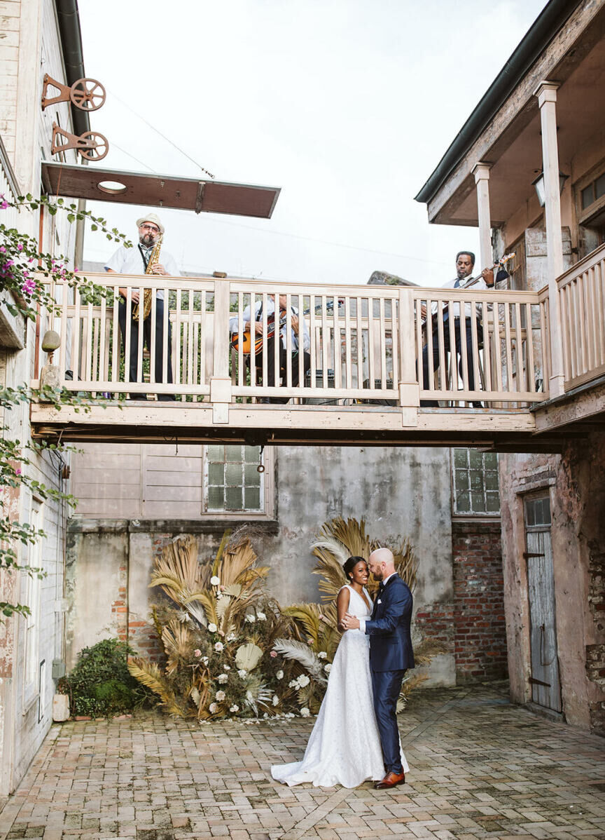 Best Places for a Minimalist Wedding: A smiling bride and groom dancing outside at Race + Religious.