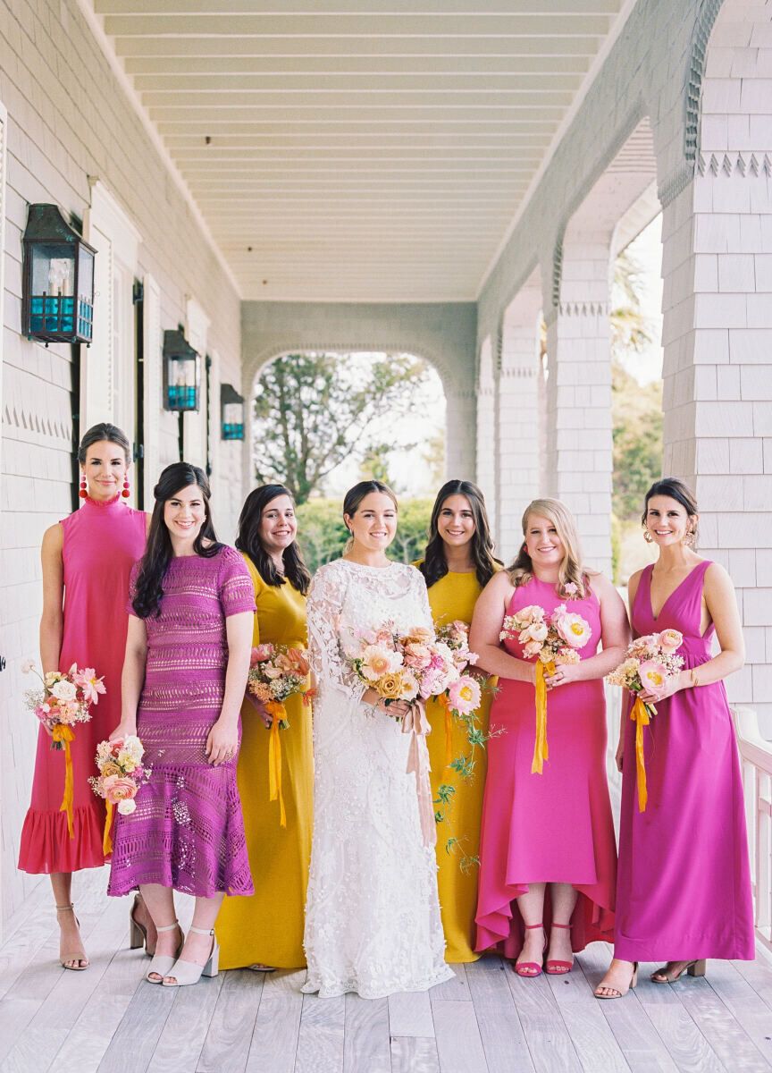 Mismatched bridesmaid dresses: See more assorted vibrant pink and yellow unique bridesmaid dresses from Lauren and Daniel's boho wedding