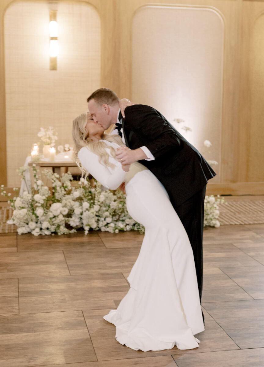 A couple kisses and a groom dips his bride during their first dance inside the ballroom of the Santa Monica Proper, where their modern California wedding took place.