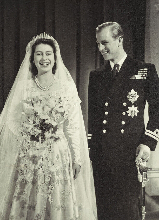 Most Influential Women in History Weddings: Queen Elizabeth in her wedding dress posing with husband Prince Philip