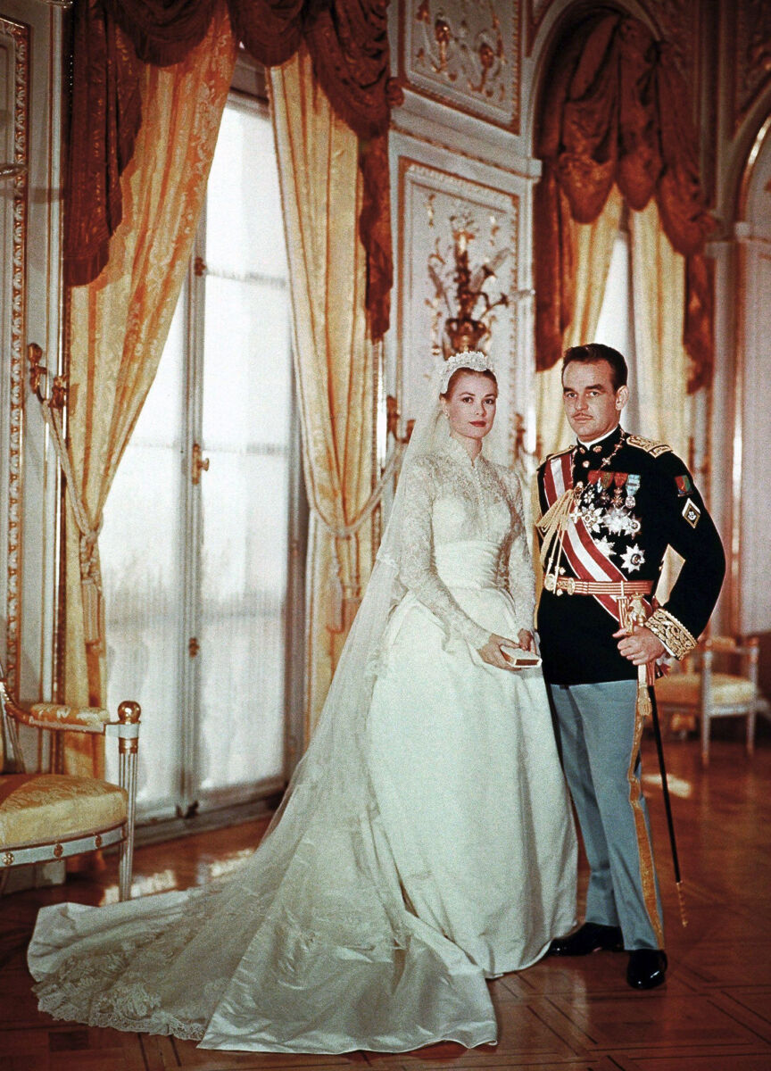 Most Influential Women in History Weddings: Princess Grace Kelly posing in her wedding dress with husband Prince Rainier III of Monaco