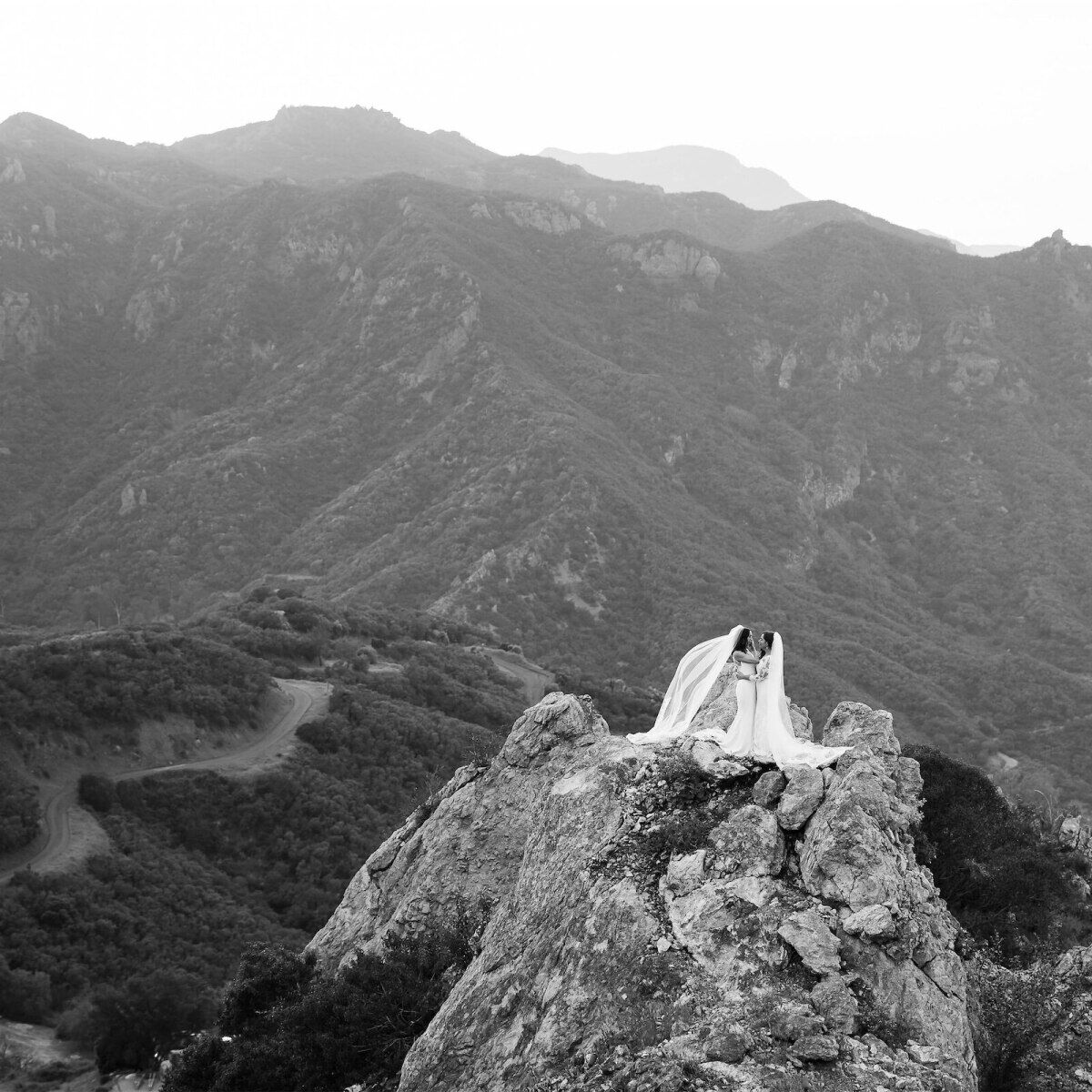 Mountain Wedding: Two brides embracing on a mountain in Malibu, California.