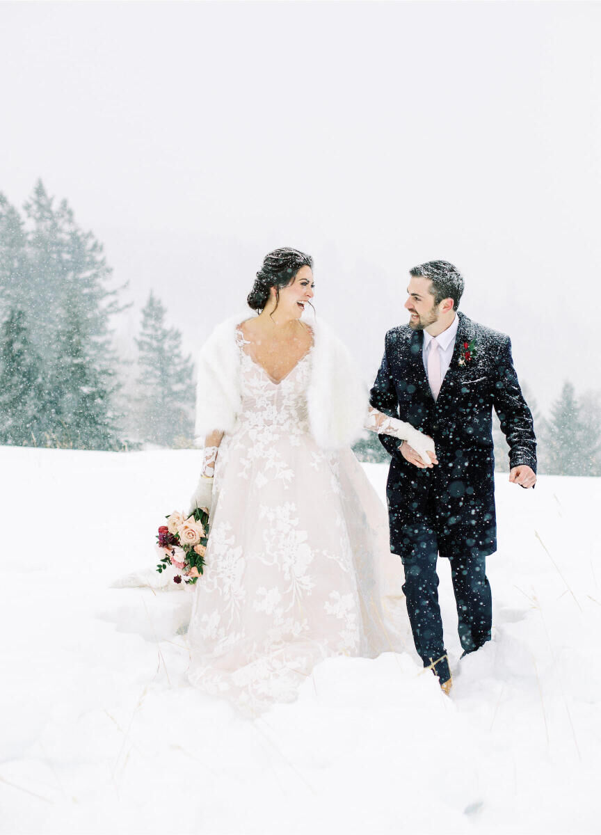 Mountain Wedding: A wedding couple laughing with each other on a snowy mountain in Colorado.