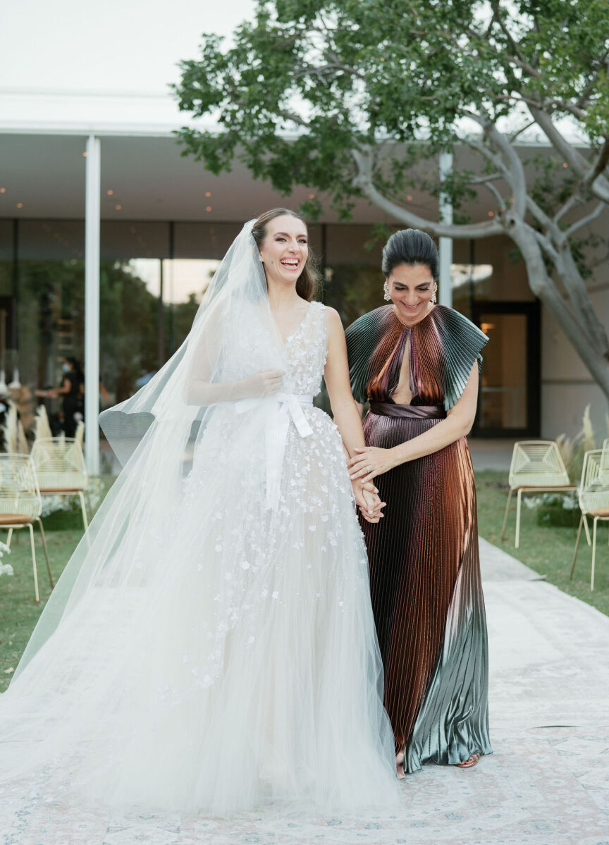 Mother of the bride escorting the bride down the aisle at her Norton Museum of Art wedding.