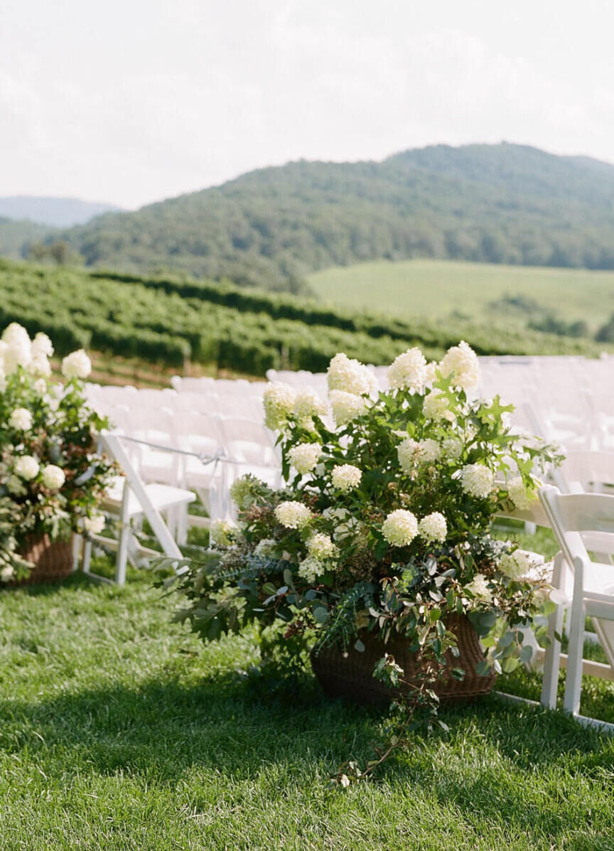 Pippin Hill Farm: A ceremony aisle with lower-to-the-ground arrangements of greenery and white flowers.