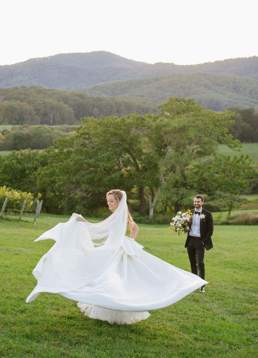 Pippin Hill Farm: A bride twirling in her wedding gown while a groom holding a bouquet looks on.