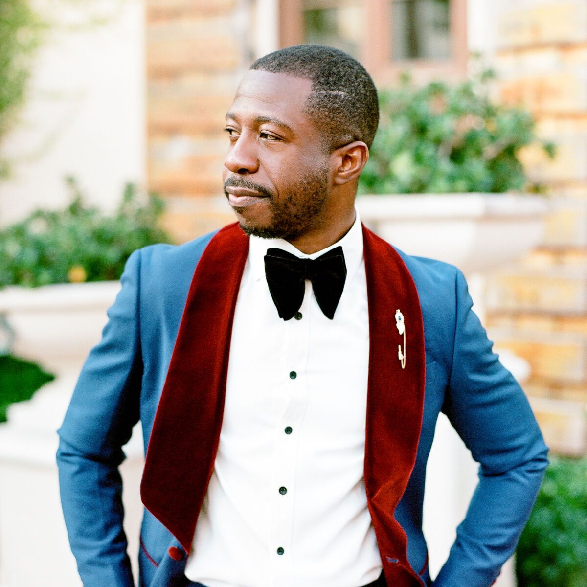 Groom posing in chic groom attire