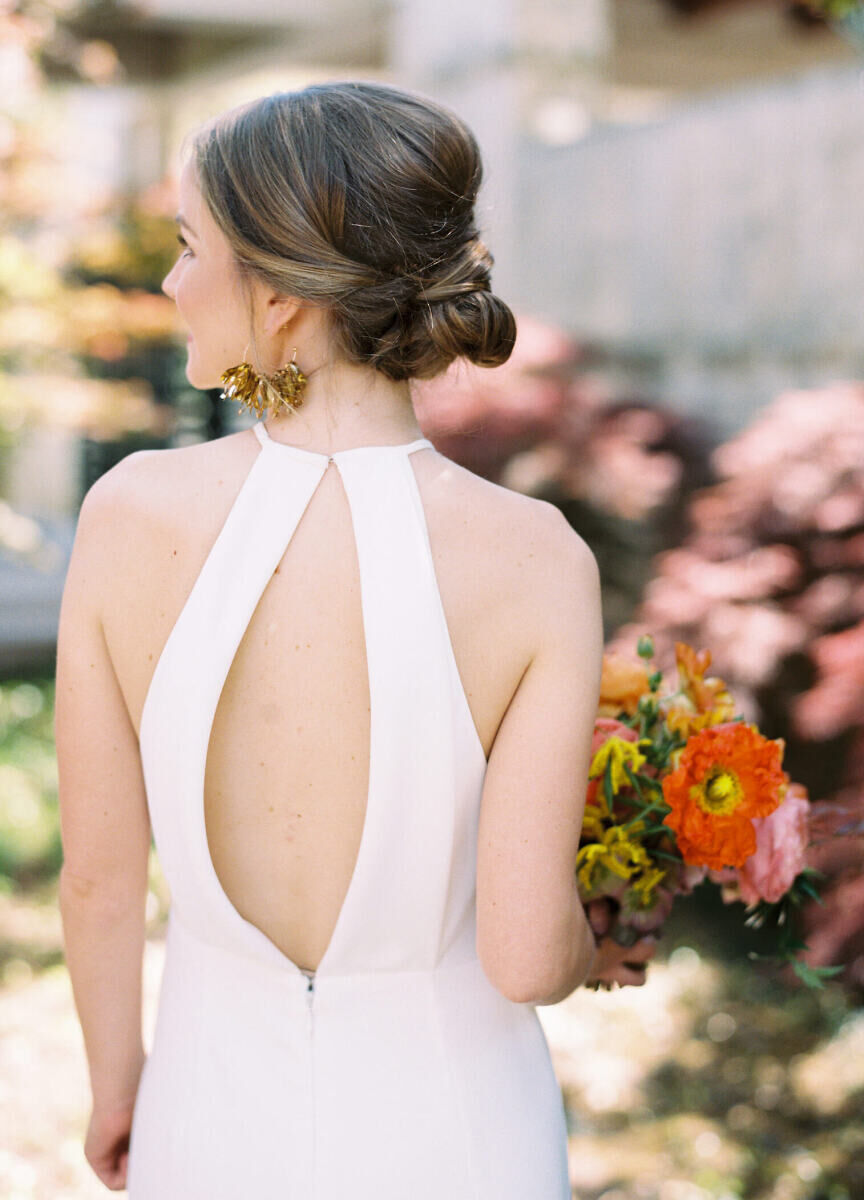 A bride's low and intricate updo allowed her open-back dress and to show off.