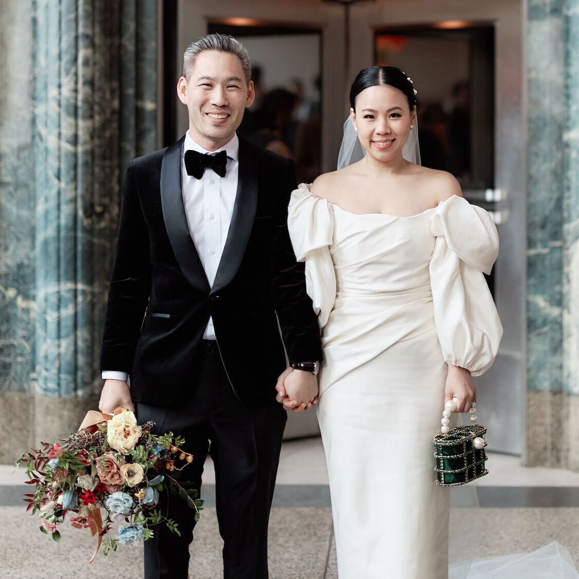 A groom and bride outside the venue of their restaurant wedding—Eleven Madison Park in lower Manhattan.