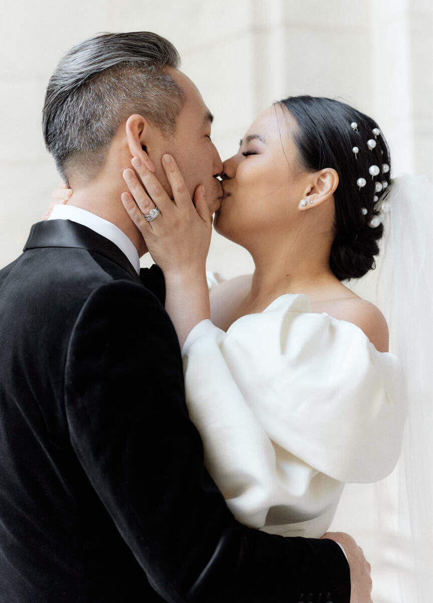 A groom and bride kiss during their portrait session prior to their restaurant wedding in Manhattan.