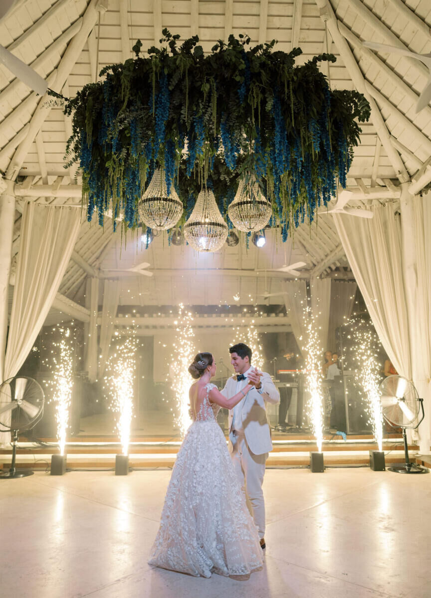 Romantic Wedding Venues: Newlyweds smiling and dancing in front of sparklers at Banyan Tree Mayakoba.