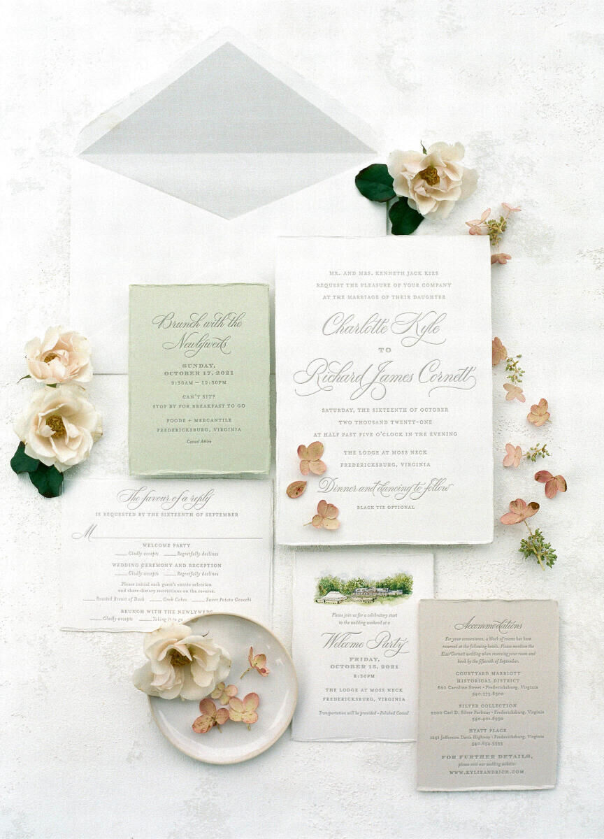 A neutral-colored invitation suite befitting a rustic outdoor wedding, with hand-torn edges and an illustration of the wedding venue.