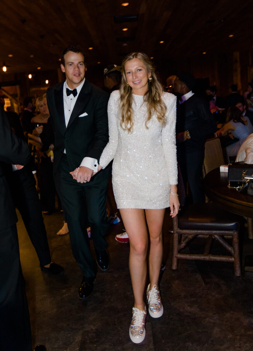 To dance the night away at their rustic outdoor wedding, the bride changed into sneakers and a sparkly mini-dress.