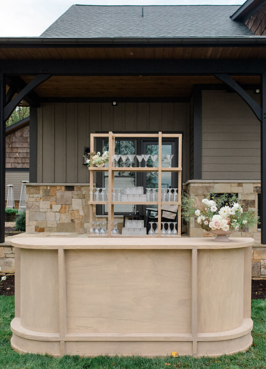 Custom bars were brought in to elevate the cocktail hour of a rustic outdoor wedding.