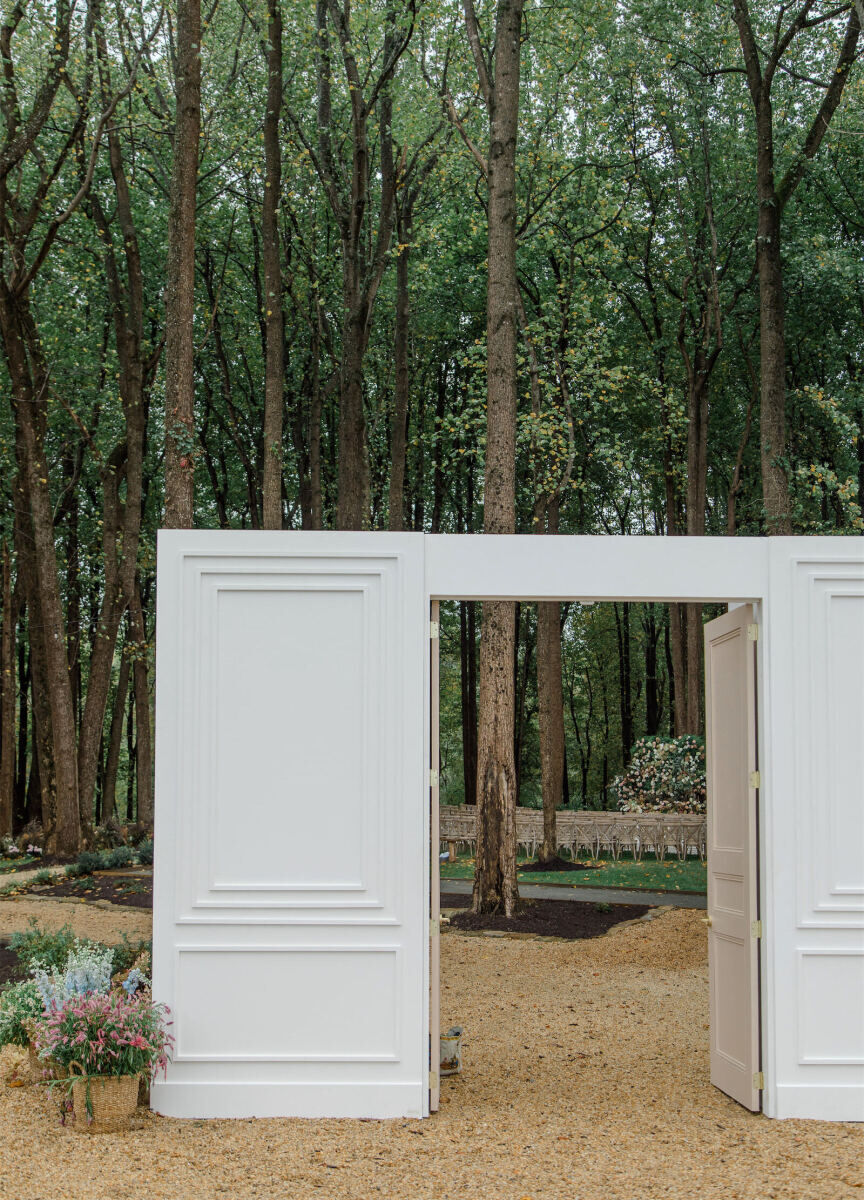 An entryway led the way to the rustic outdoor wedding ceremony in the woods.