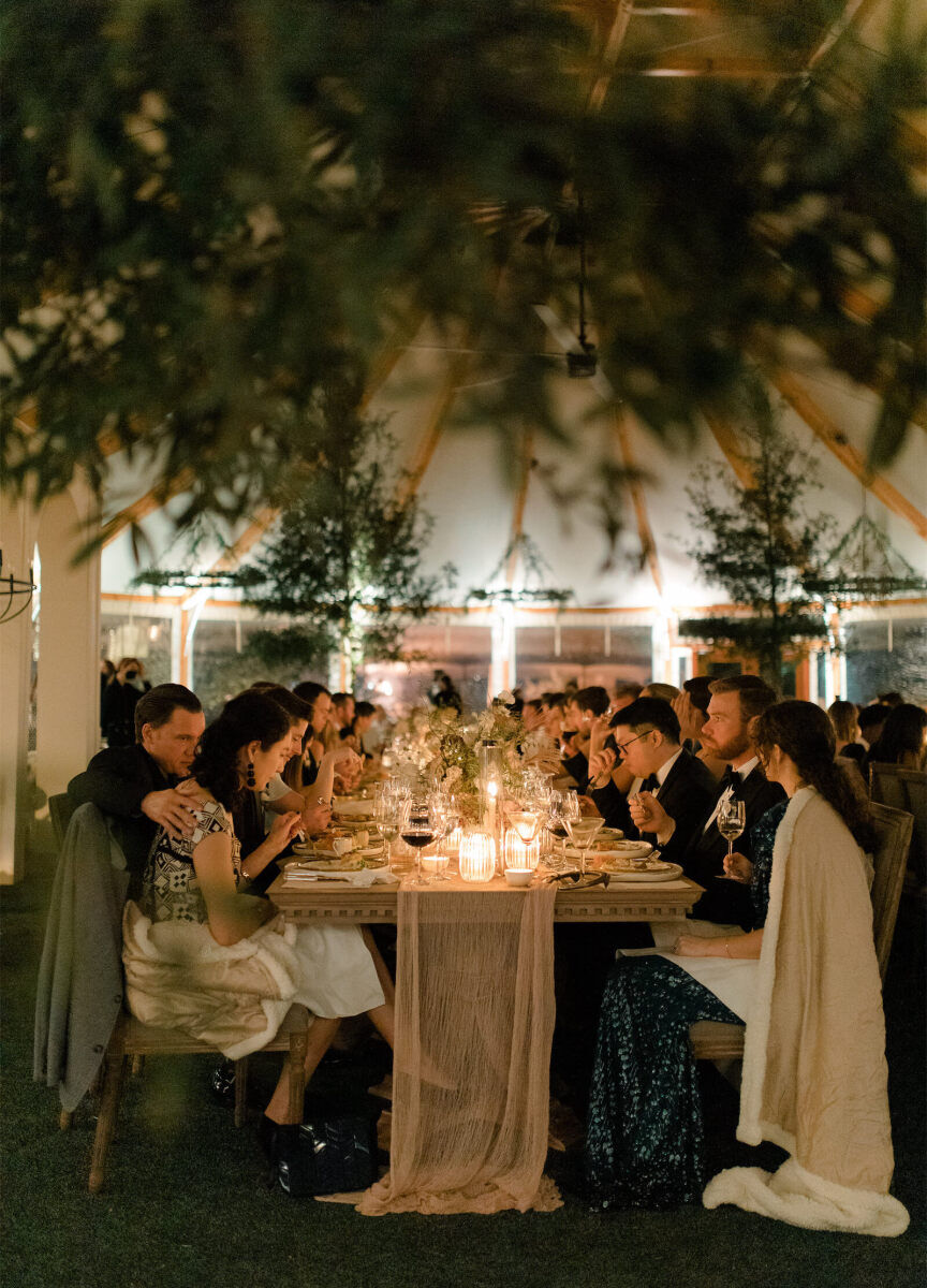 Guests enjoy dinner at a rustic outdoor wedding in rural Virginia.