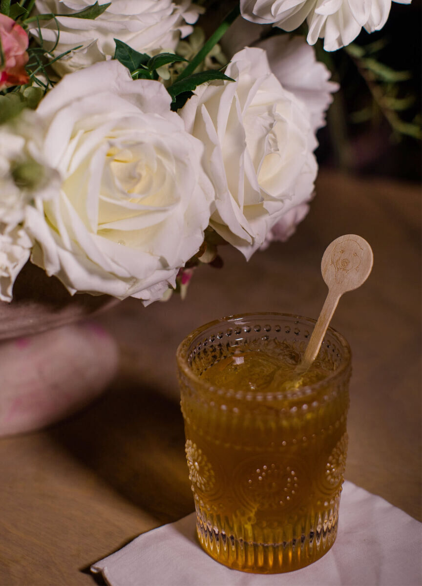 Drink stirrers with an illustration of a bride and groom's dog were used in the cocktails at their rustic outdoor wedding.