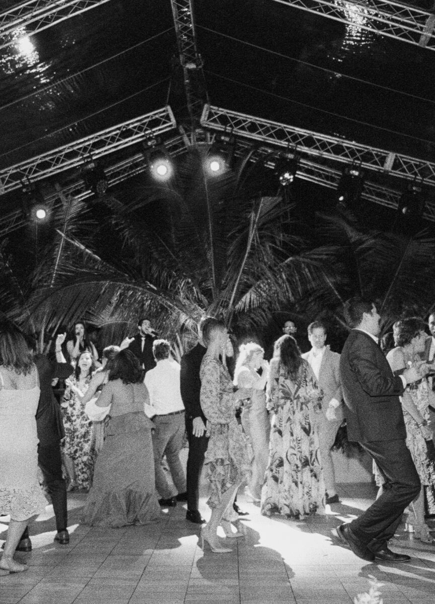 Tropical Wedding: Wedding guests dancing on an outdoor dance floor.