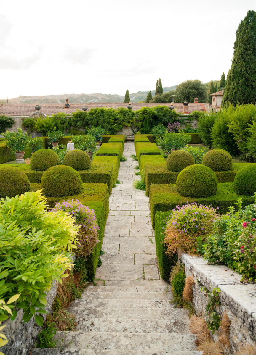 A Tuscan wedding venue with manicured gardens and rolling countryside views.