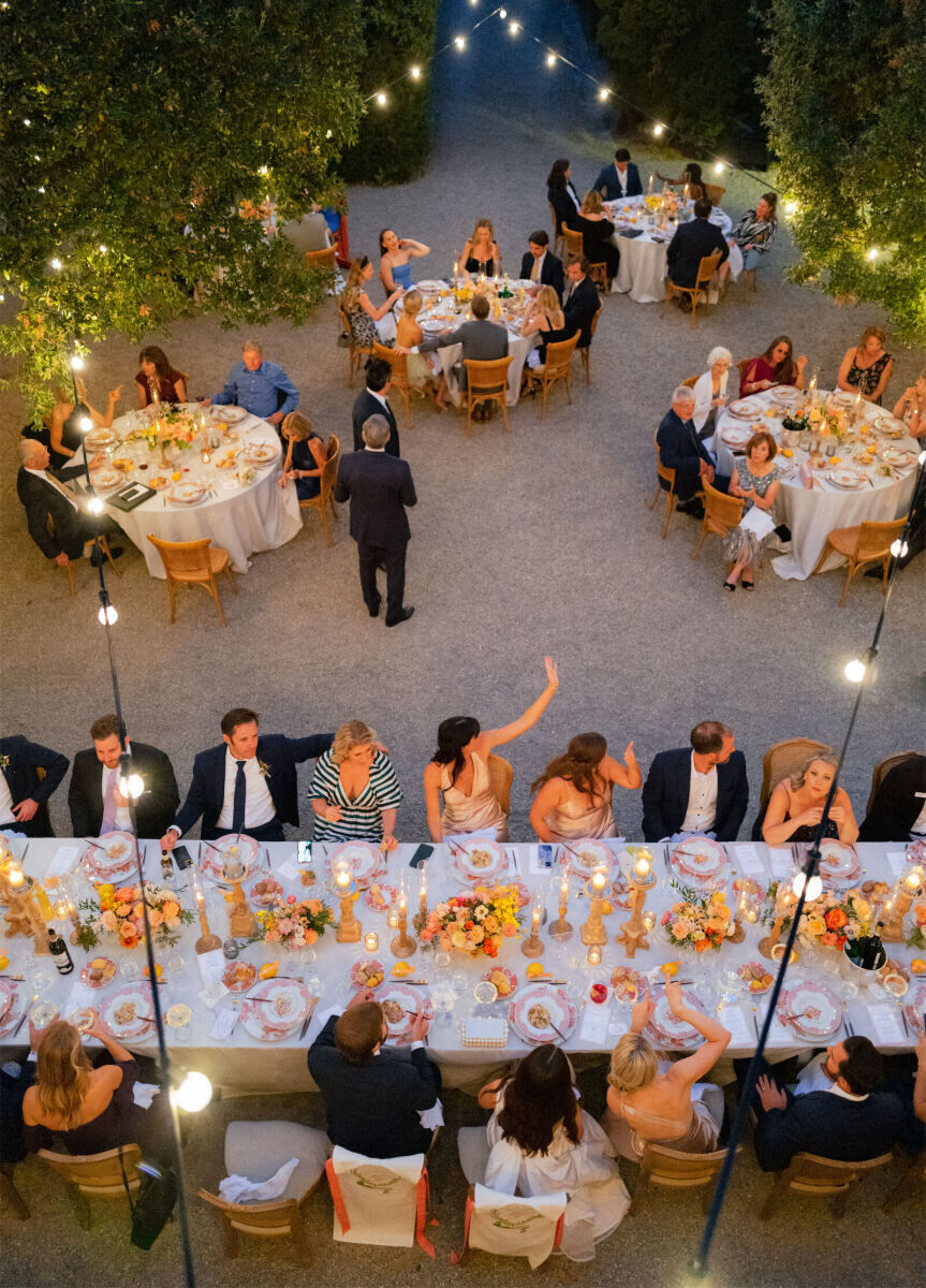 Guests enjoy an outdoor reception at a Tuscan wedding.