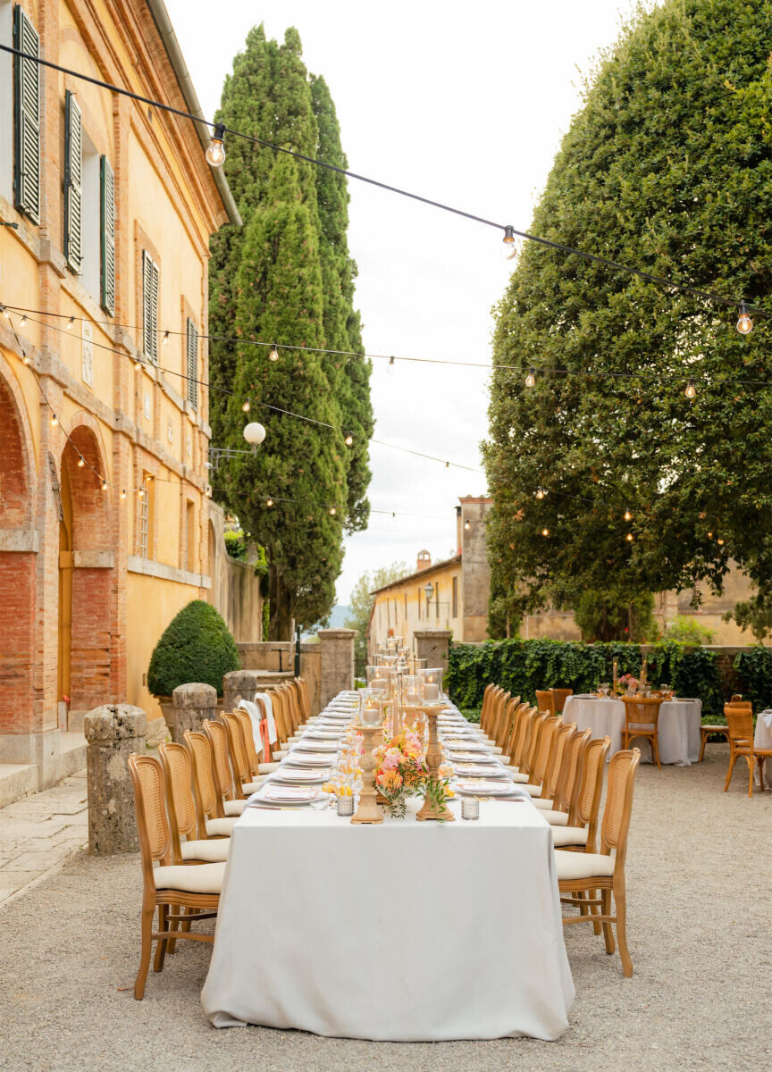 A Tuscan wedding reception set in the courtyard of La Foce, a villa in Italy.