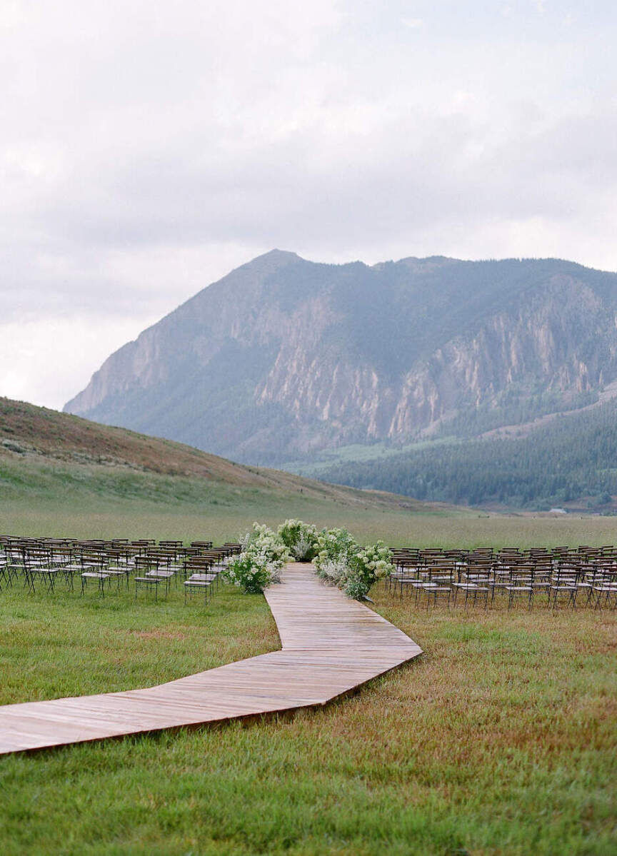 Wedding Aisle: A wooden wedding aisle leading up to an altar with mountains and hills beyond.