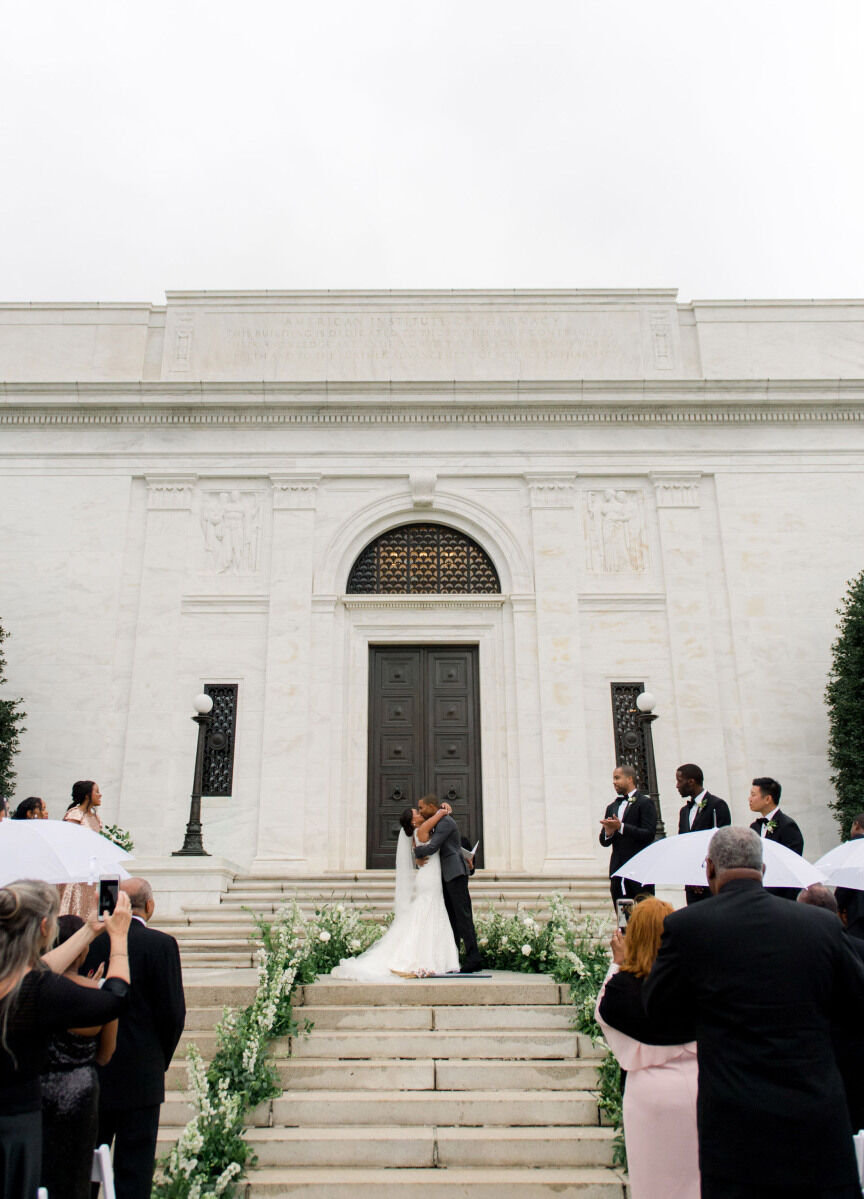 Wedding Aisle: A bride and groom sharing their first kiss at the top of a staircase serving as an aisle.