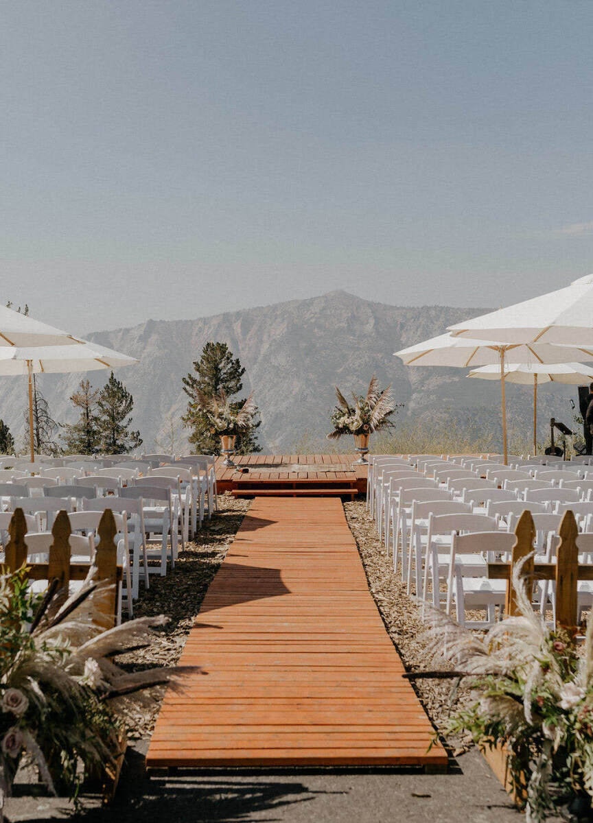 Wedding Aisle: A wooden aisle with pampas grass arrangements decorating both the start and end.