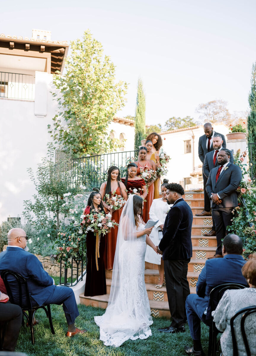 Wedding details: A bride and groom during their ceremony on a staircase.