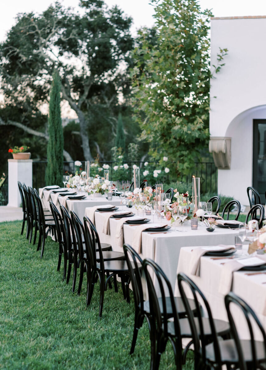 Wedding details: Long reception tables set with black chairs and modern place settings.