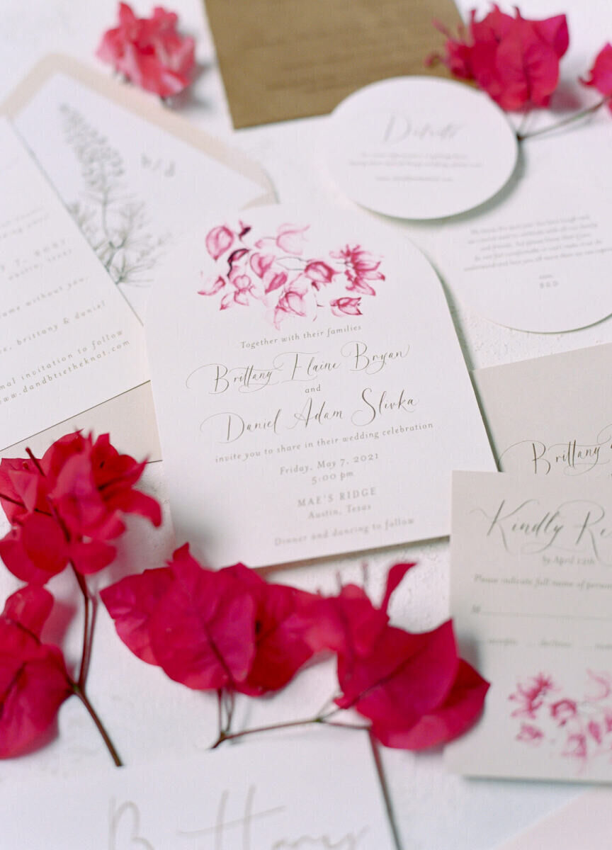 Pink wedding details: A modern wedding invitation with floral illustrations and calligraphy.