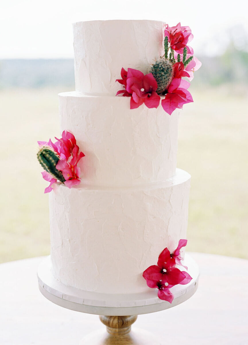 Pink wedding details: A three-tier wedding cake with bougainvillea and tiny cacti decorations.