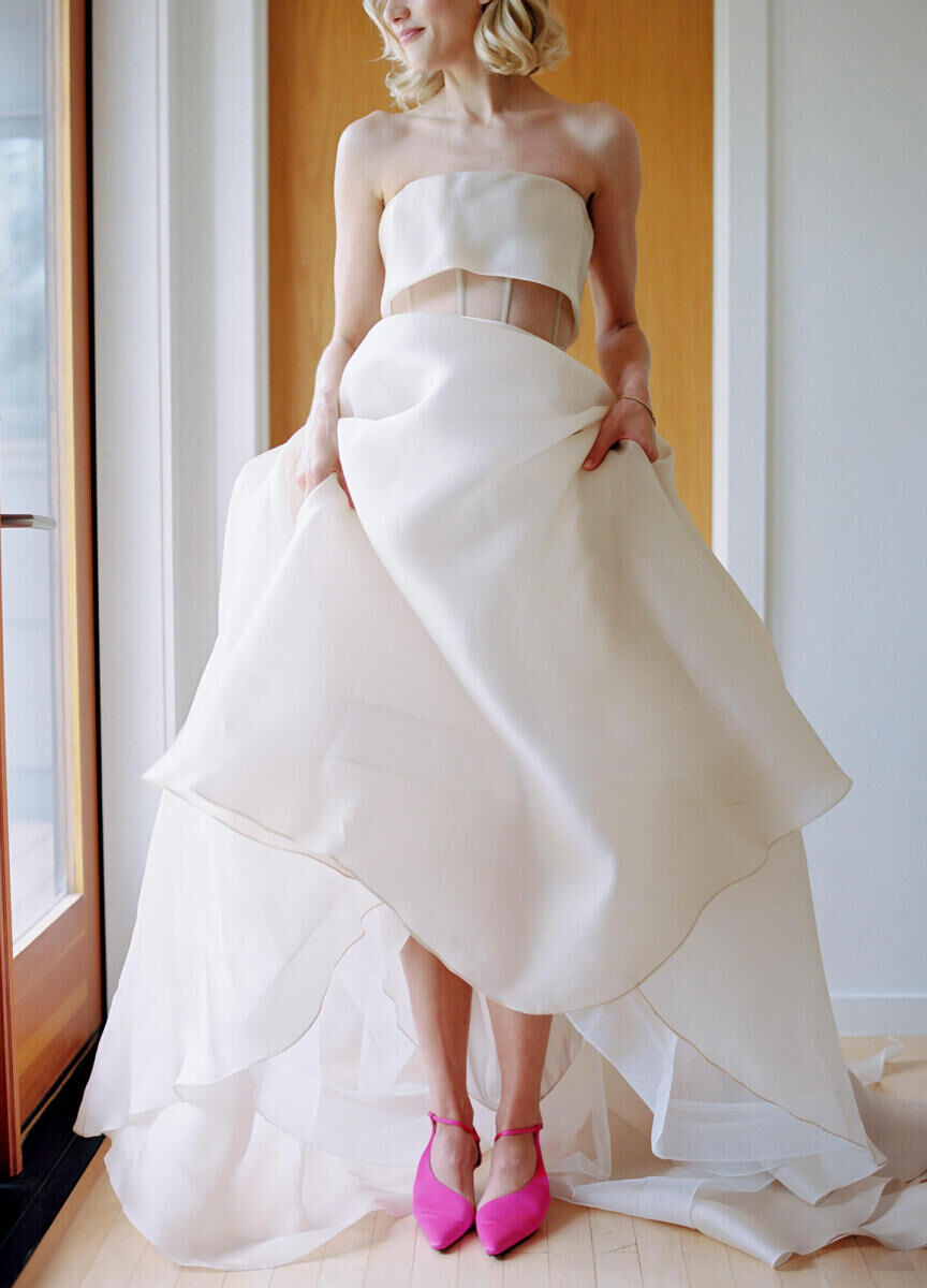 Pink wedding details: A bride showcases one of her colorful wedding details: her hot pink shoes.