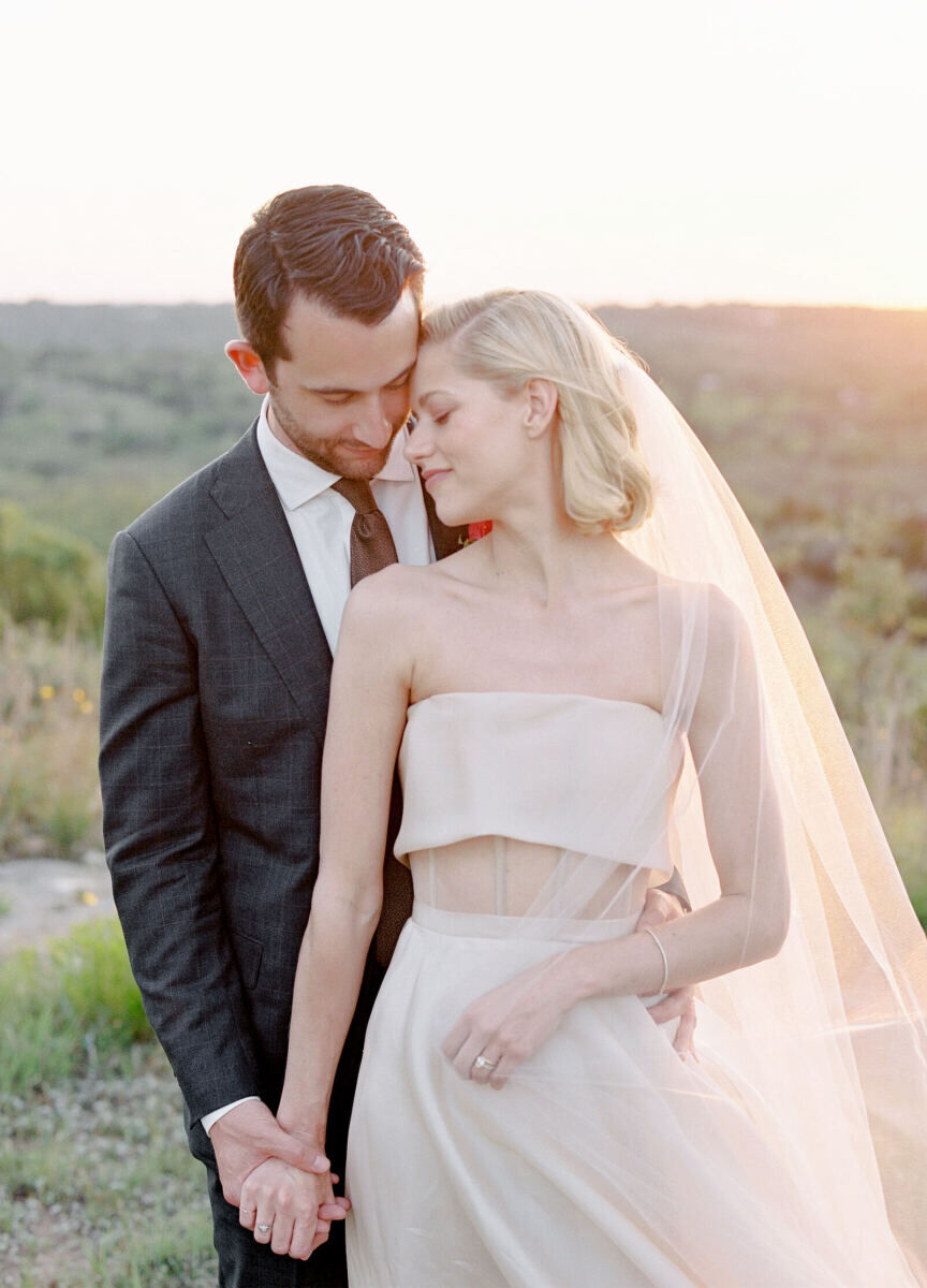 Pink wedding details: A bride and groom pause for portraits at golden hour.