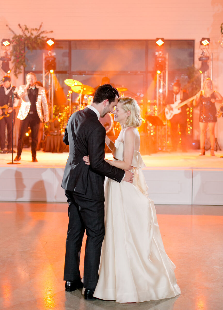 Pink wedding details: A wedding band plays as a bride and groom share their first dance as newlyweds.