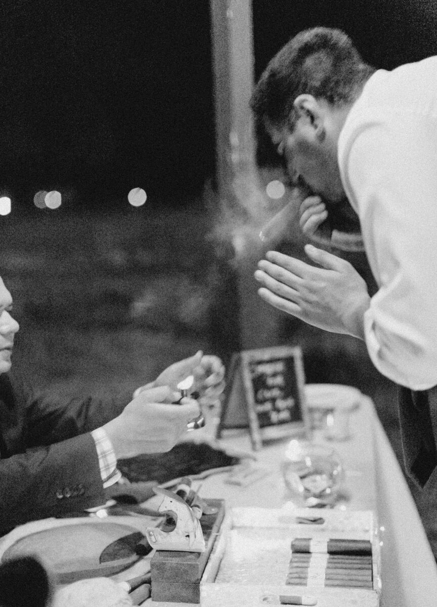 Pink wedding details: A wedding guest enjoys a hand-rolled cigar.