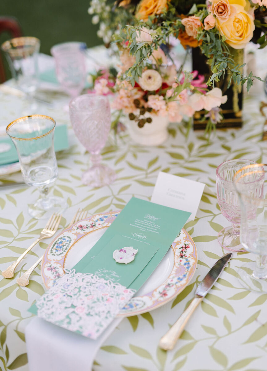 Wedding reception tables set with a mix of candles, floral centerpieces, and animal figurines.