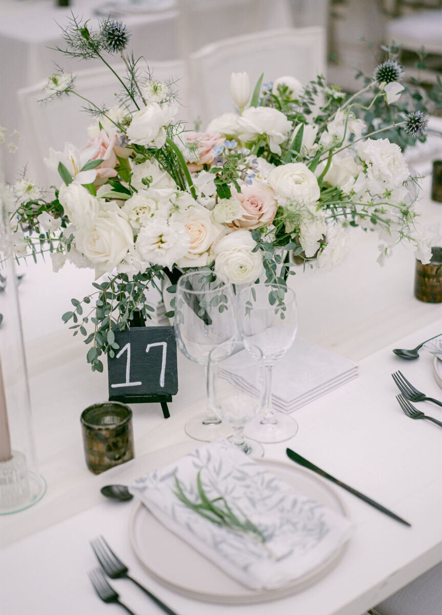 Wedding details: Wedding reception table featuring centerpieces with eucalyptus