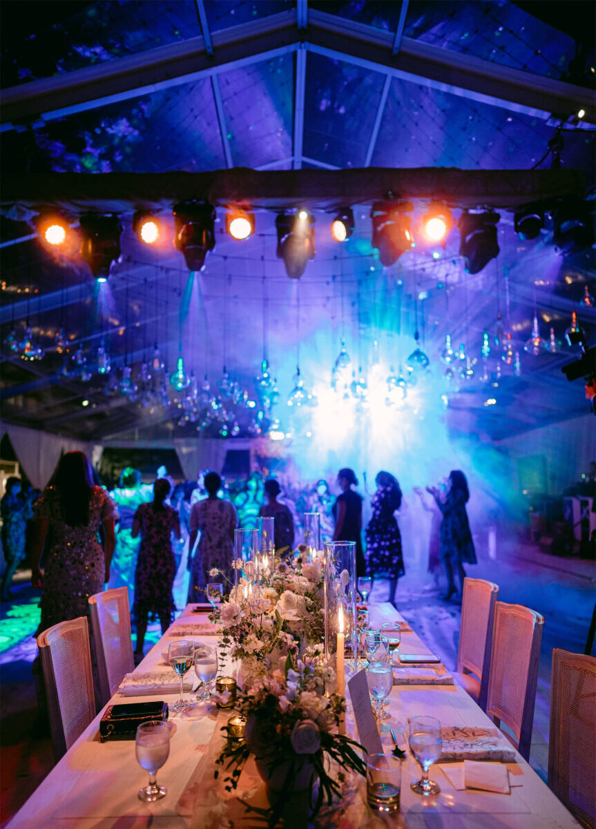 Wedding details: After hours wedding party, guests dancing in a dark tent with glowing blue lights