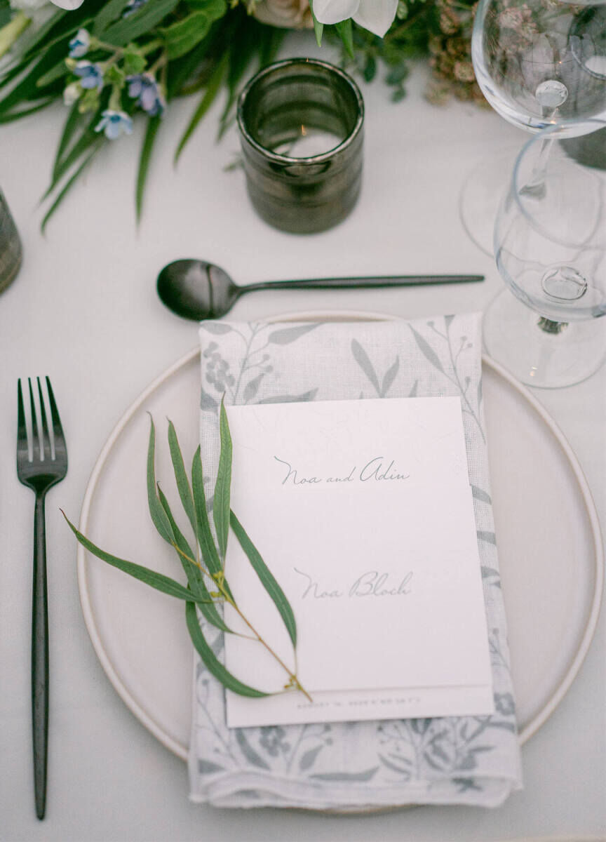 Wedding details: Modern silverware and plates paired with a floral-printed napkin at each place setting.