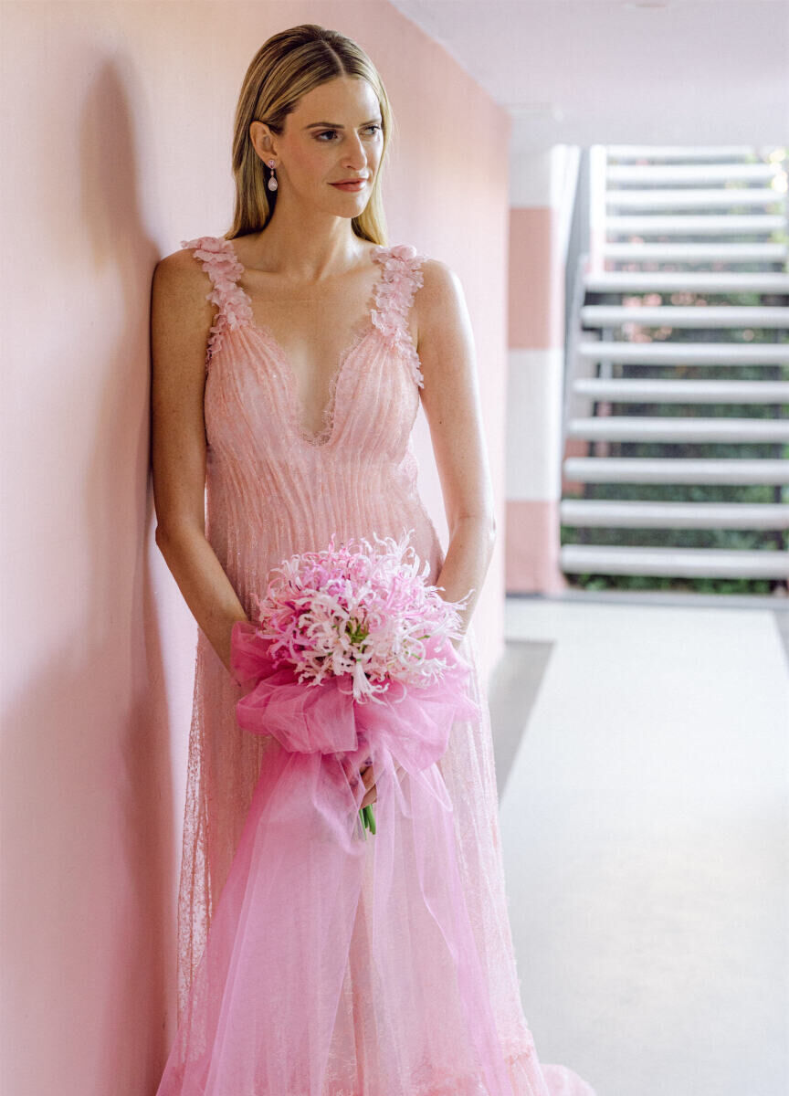 Wedding Dress Shopping: A bride wearing a pink dress with a pink bouquet.