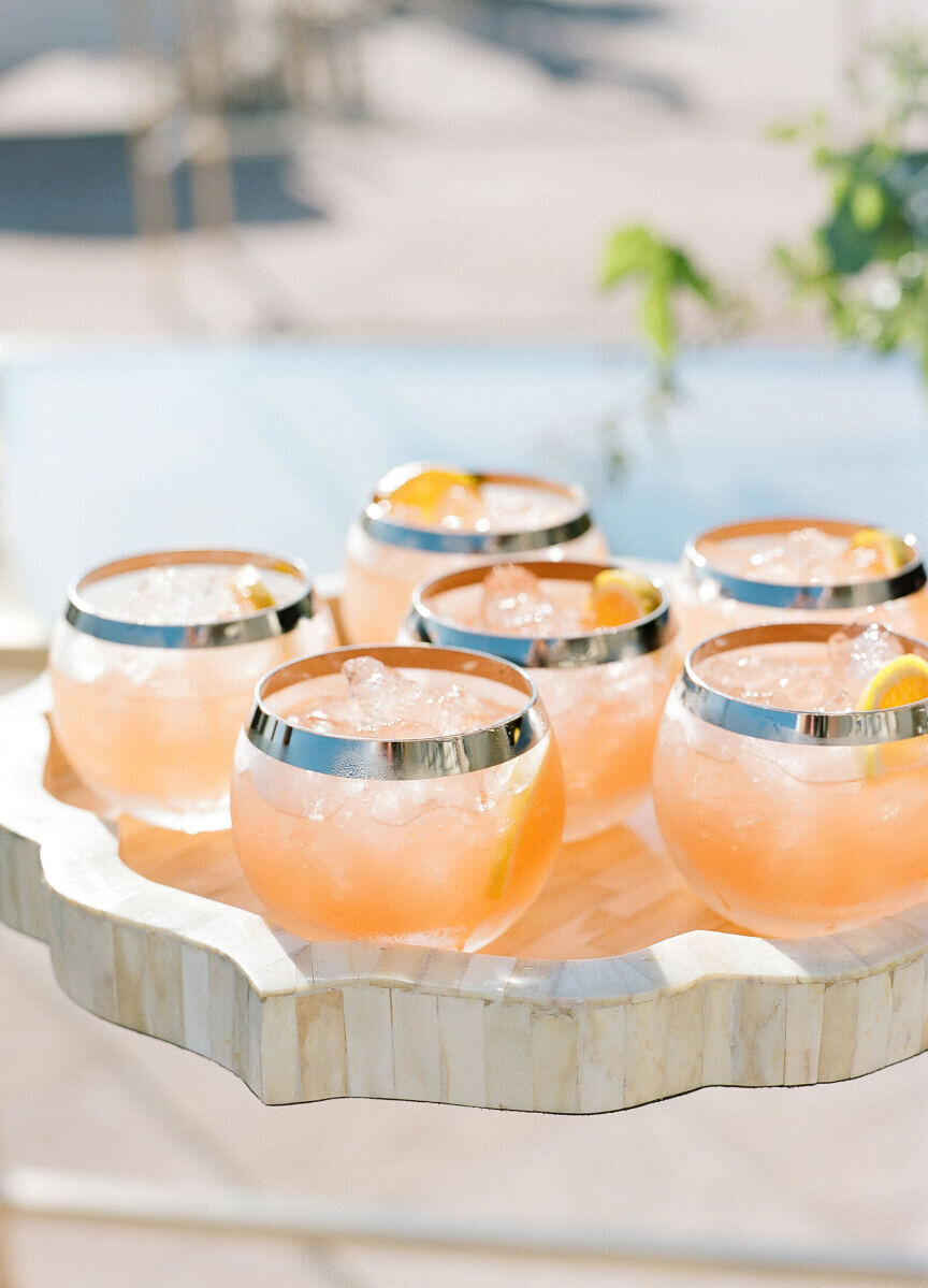 Wedding Drinks: Six peach-colored drinks on a tray.