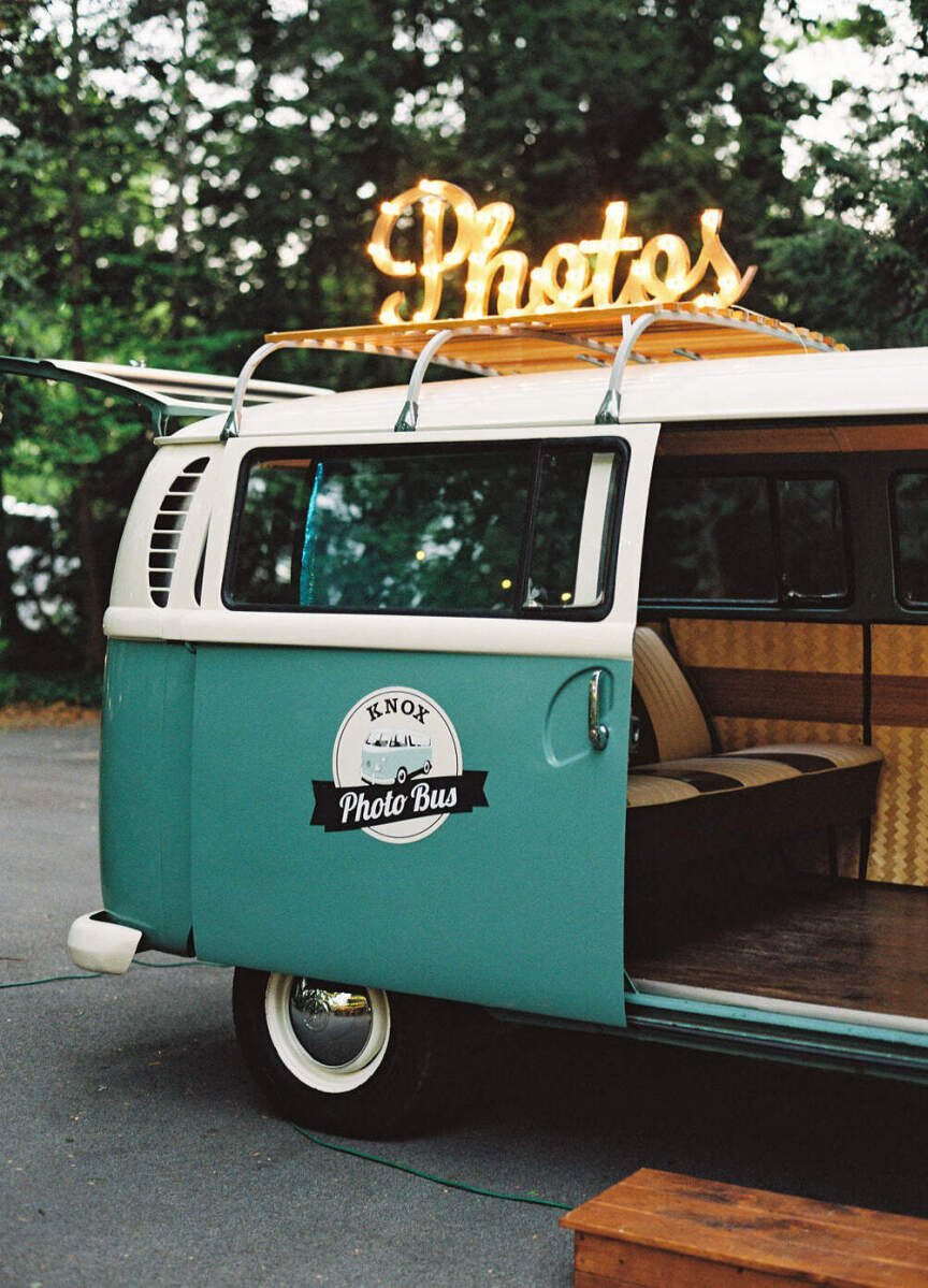 Wedding Etiquette Budget: A repurposed teal VW wagon designed to work as a photo booth with a light-up 