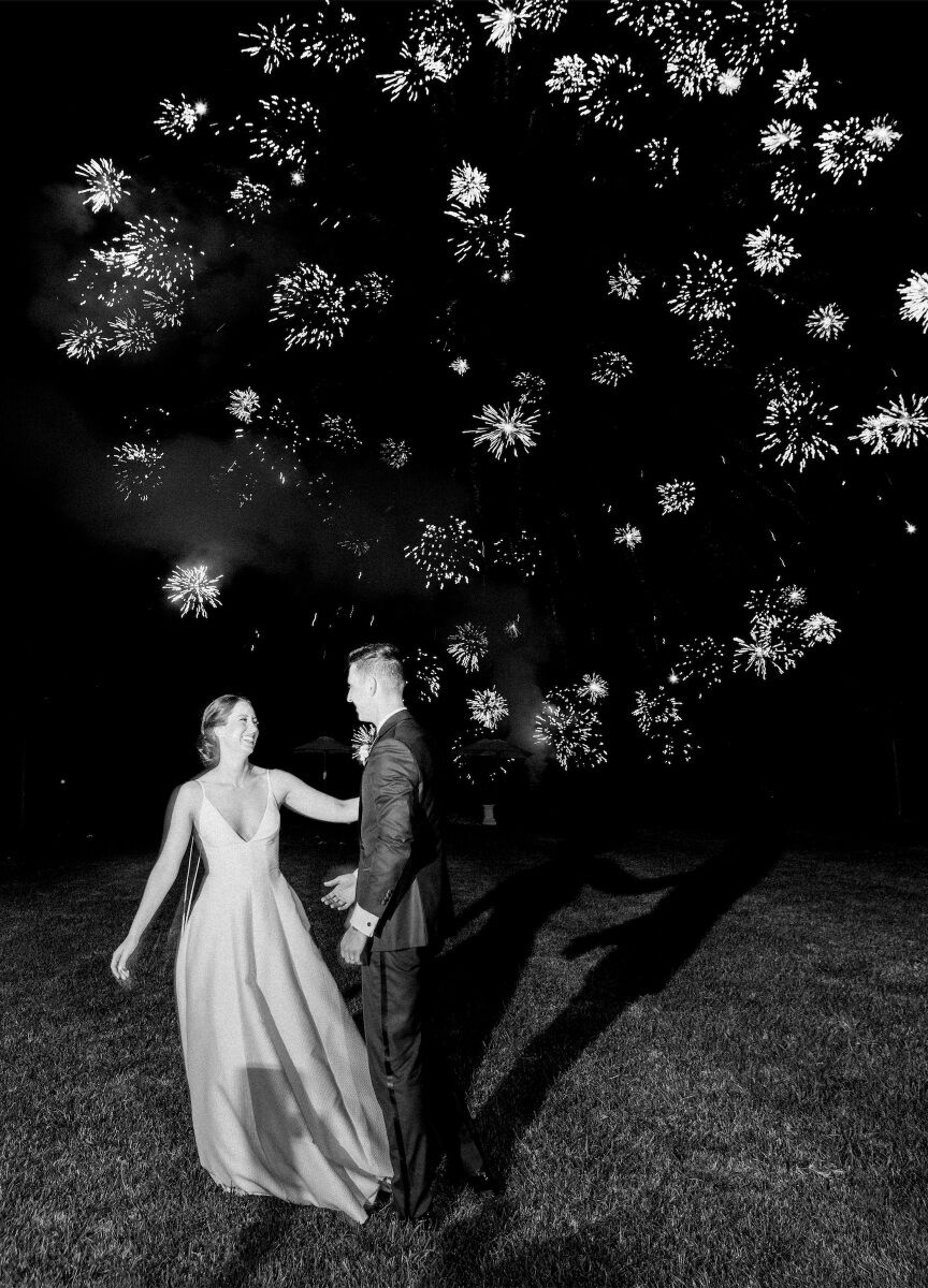 Wedding Fireworks Wedding Sparklers: A wedding couple smiling at each other with several fireworks going off in the background.