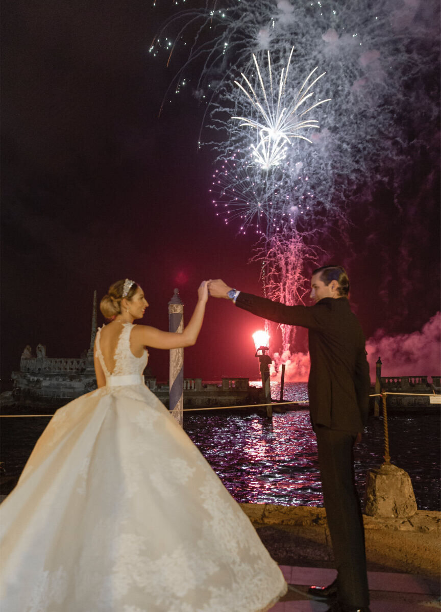 Wedding Fireworks Wedding Sparklers: A groom twirls his bride near a firework display.