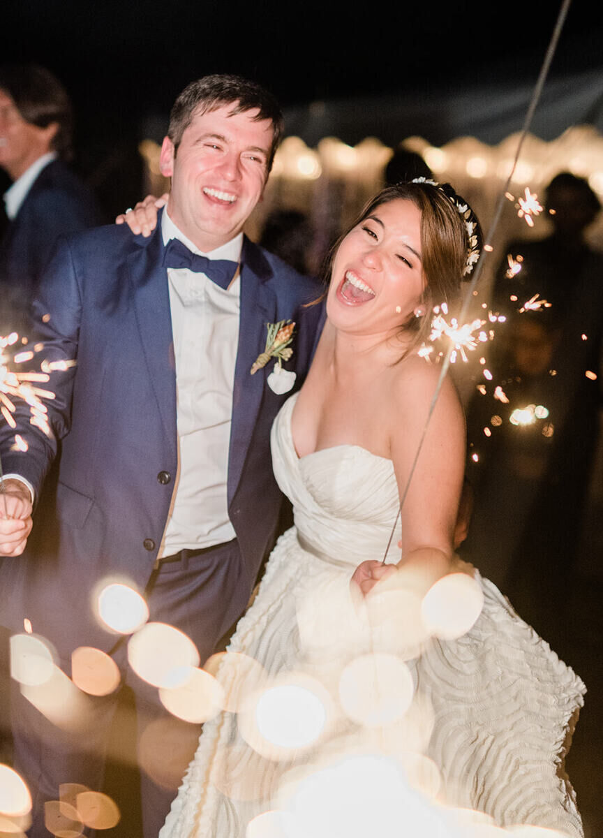 Wedding Fireworks Wedding Sparklers: A wedding couple smiling while holding sparklers.