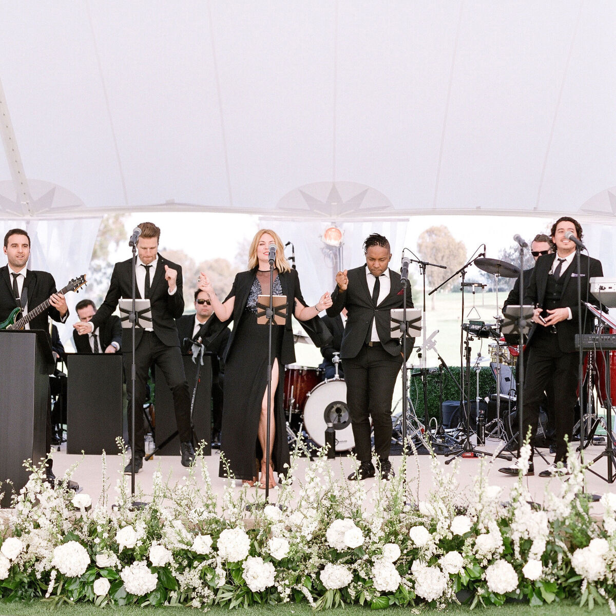 Wedding musician vendor West Coast Music on stage at wedding reception