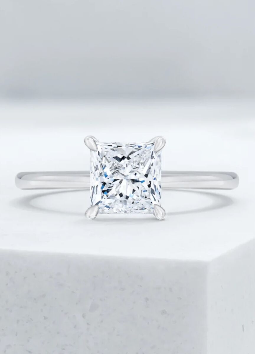 Wedding Ring Design: A princess cut diamond with a silver band.